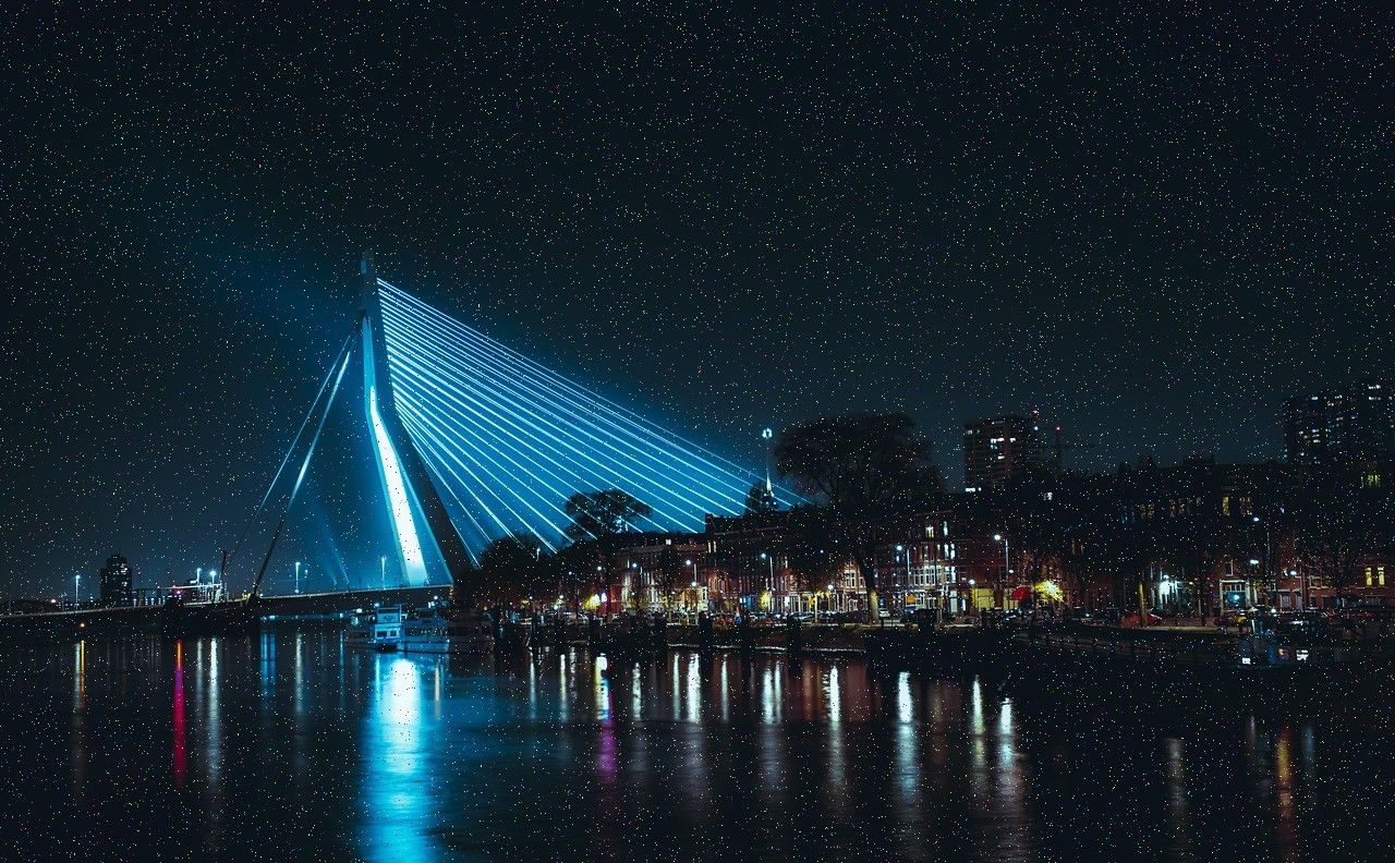 Illuminated bridge over a river at night