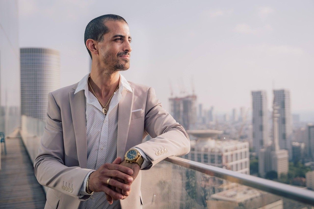 Businessman in a suit with a city skyline behind him