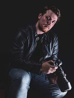 Camera operator holding a professional camera