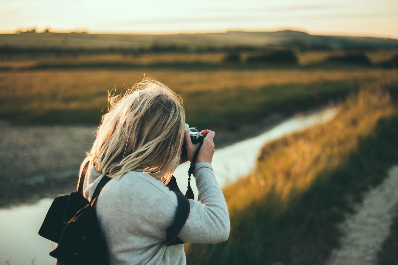 Photographer framing a shot in a golden field